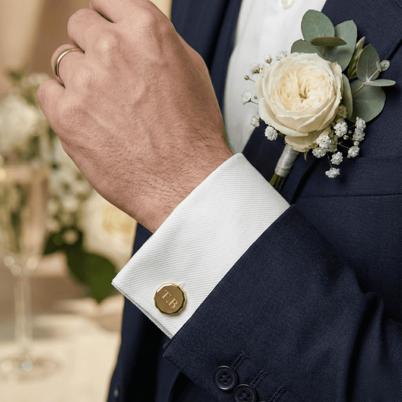 Navy suit with white shirt, gold cufflinks, and a floral boutonniere. #cufflinks #giftset