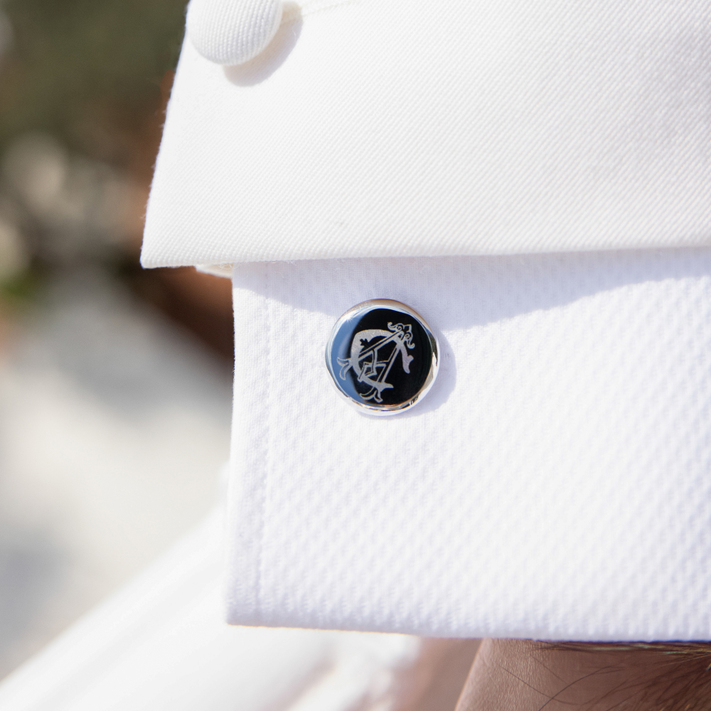 Personalised silver cufflink engraved with custom monogram, worn on crisp white shirt, perfect for groomsmen